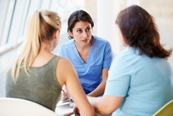 Doctor discussing condition with woman and her daughter