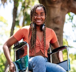 woman in wheelchair outside enjoying the sun