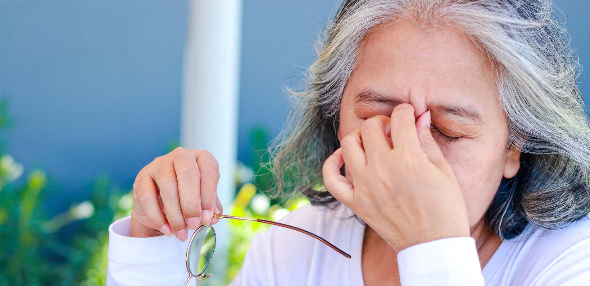 woman rubbing her eyes
