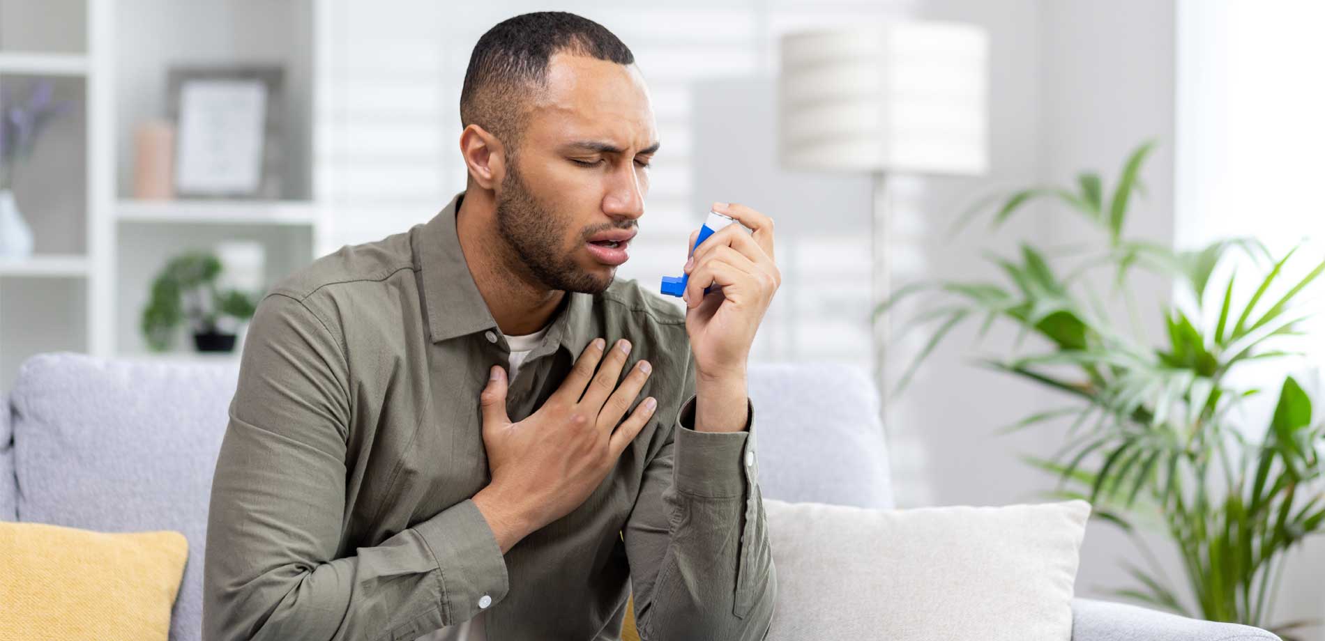 man using asthma inhailer