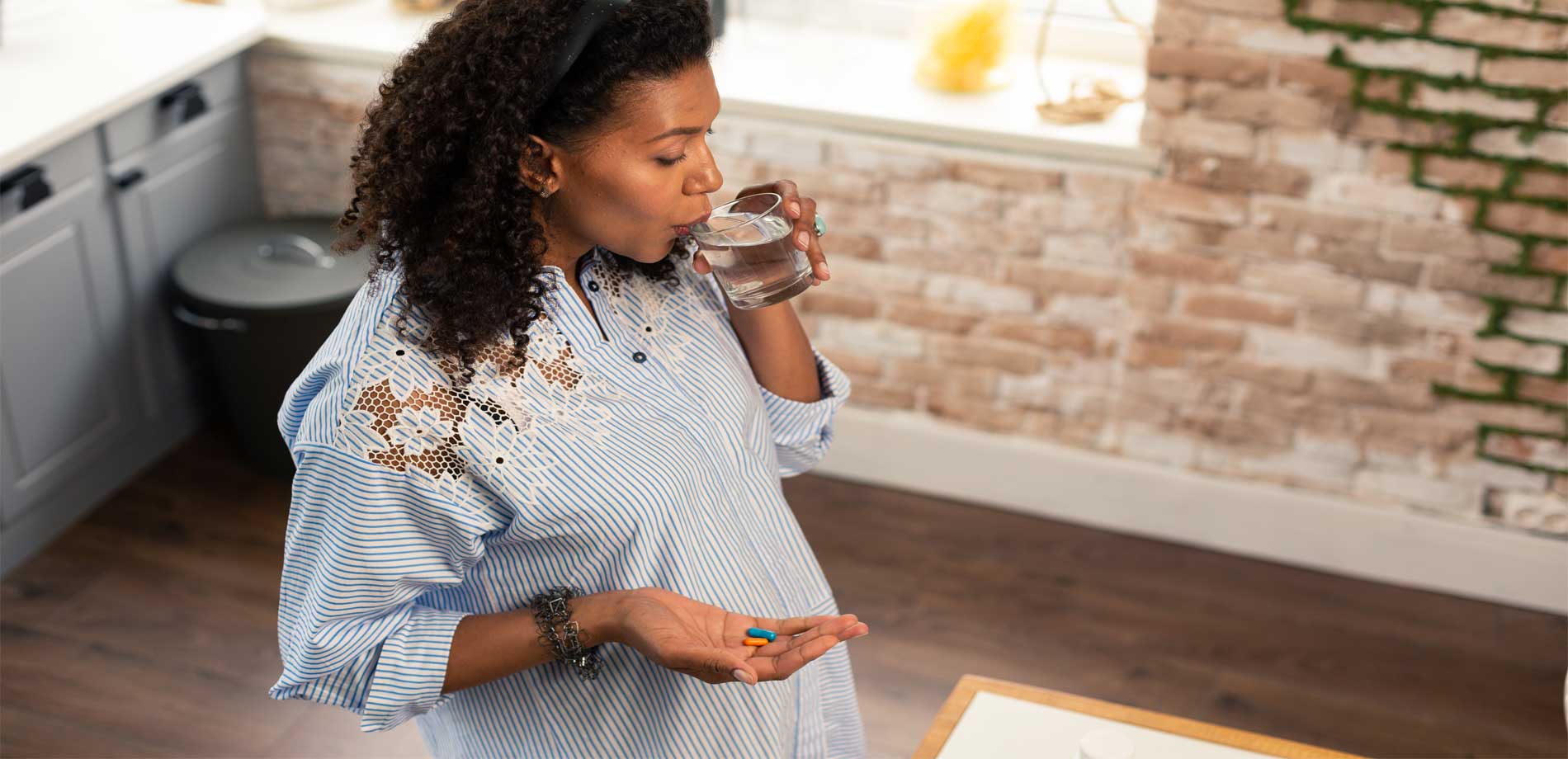 Pregnant woman taking vitamins