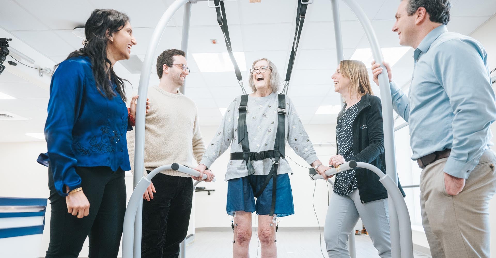 Woman doing therapy in the Gate lab, surrounded by her medical team.
