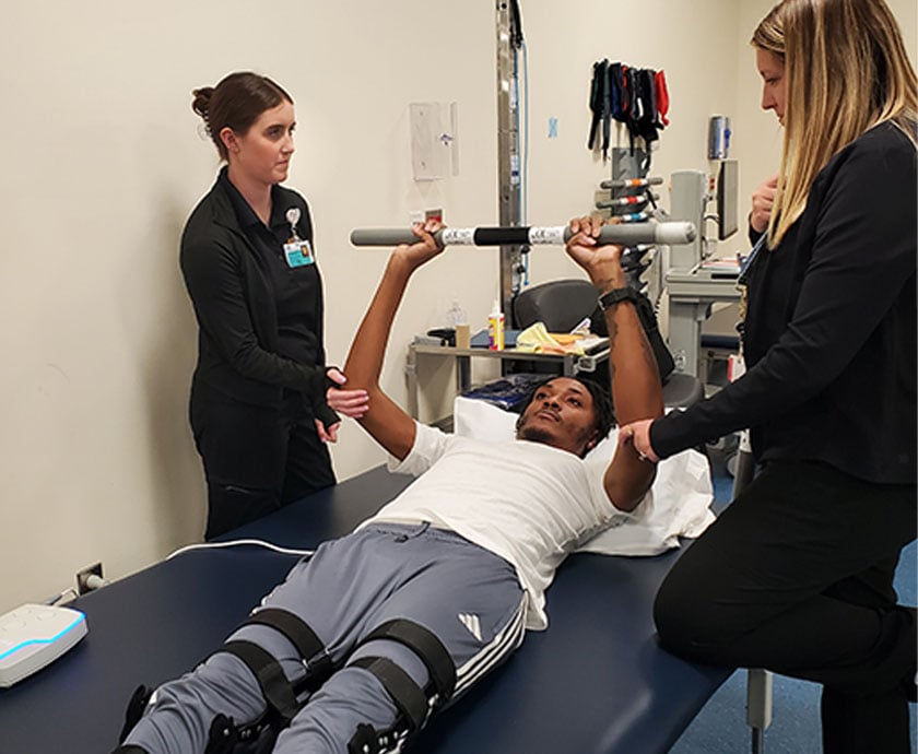 sci patient lying down bar press