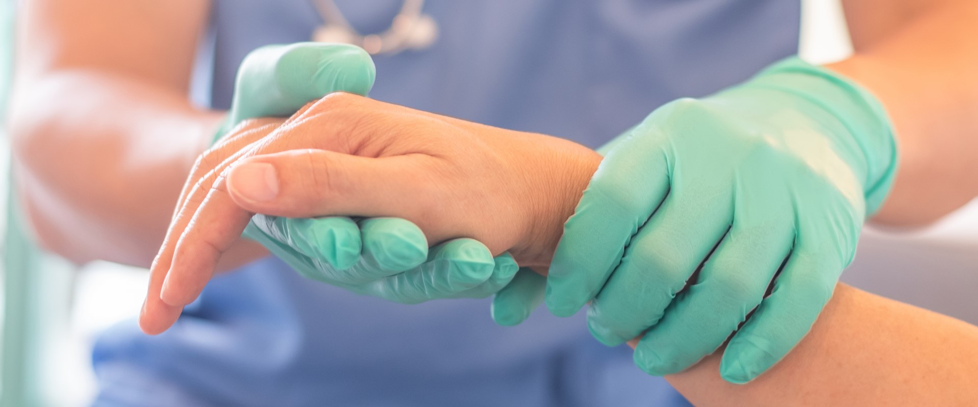 Doctor in gloves holding patient hands