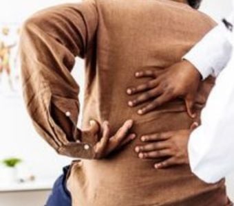 A man pointing out his sore back to his provider