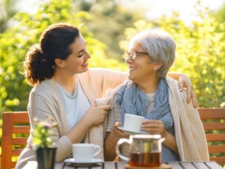 An elderly mother and her daughter spending time outside