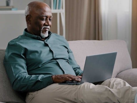 A man using his laptop in his home