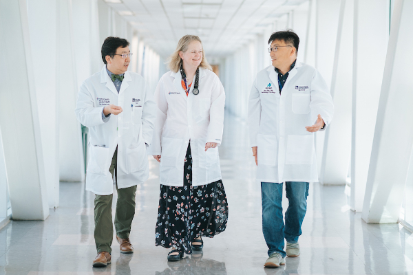 Cancer Research team walking in hallway