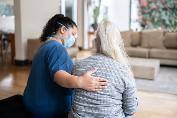A social worker comforting a patient