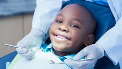 Boy in dentist chair smiling