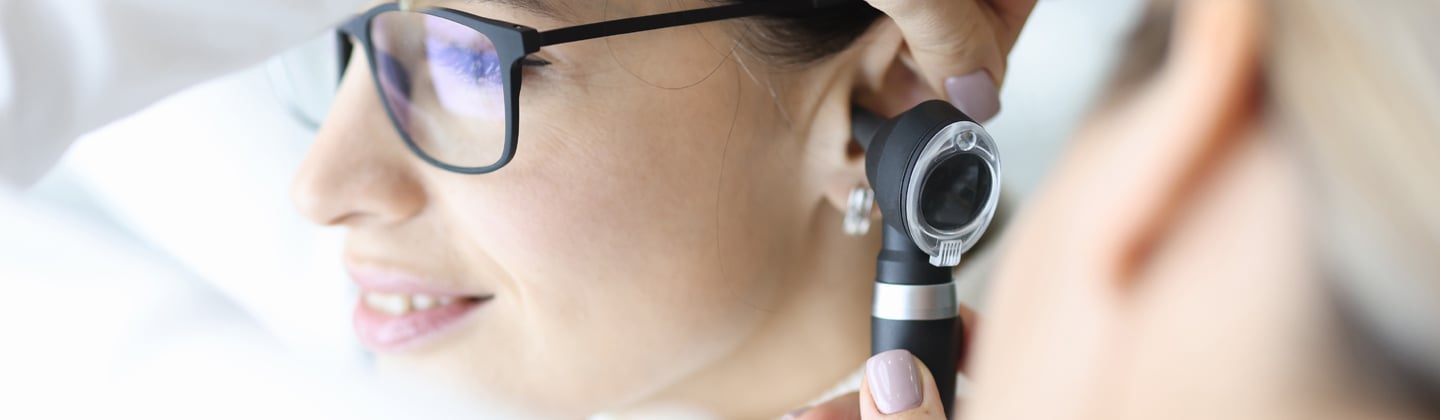 Doctor looking in patient ear