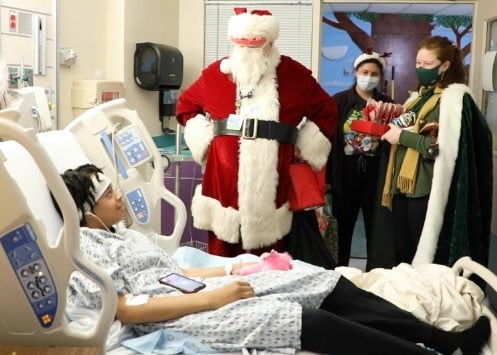 Person dressed as Santa with patients