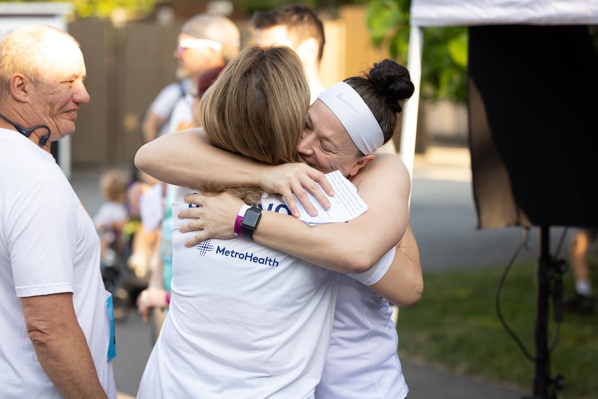 Runners sharing a hug to celebrate