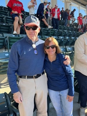 Diane and Jerry standing together in the seats at the Progressive Field baseball stadium