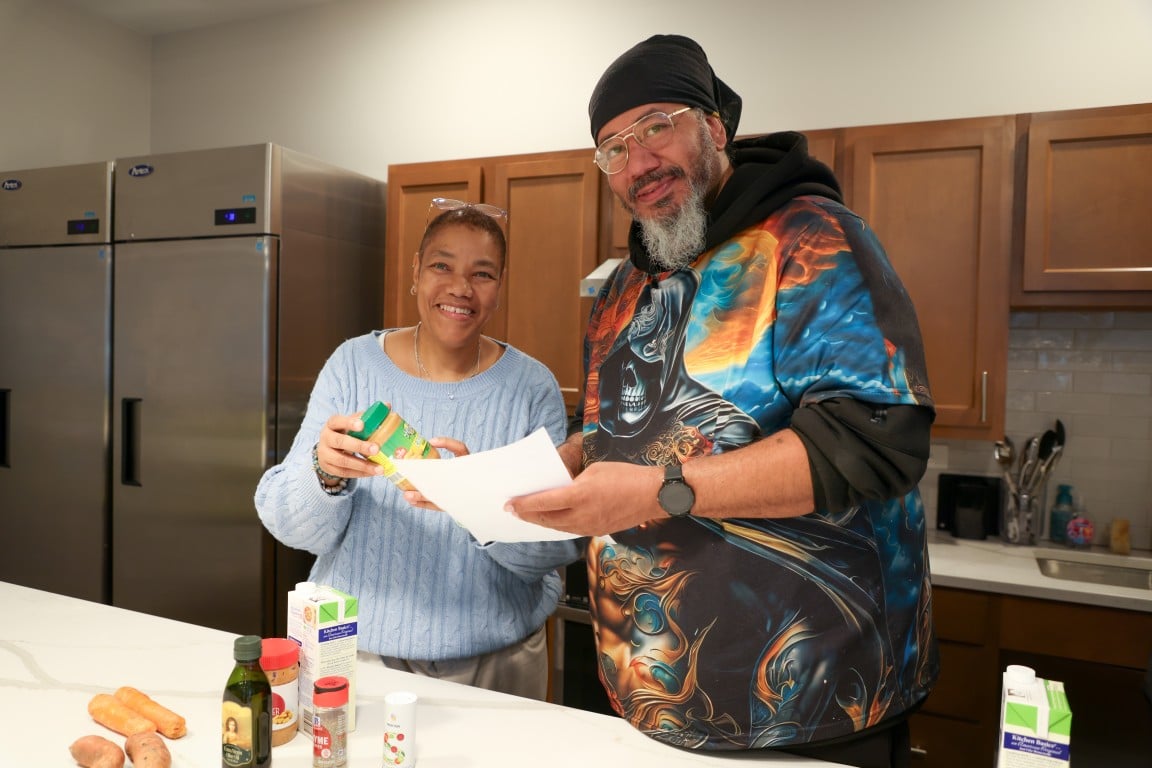 Pat Hardy and Henry Harris in a kitchen
