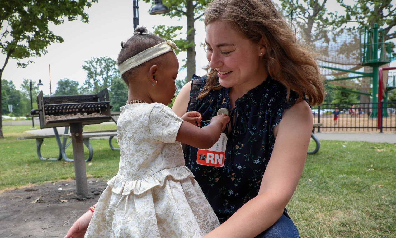 A MetroHealth nurse holding a child