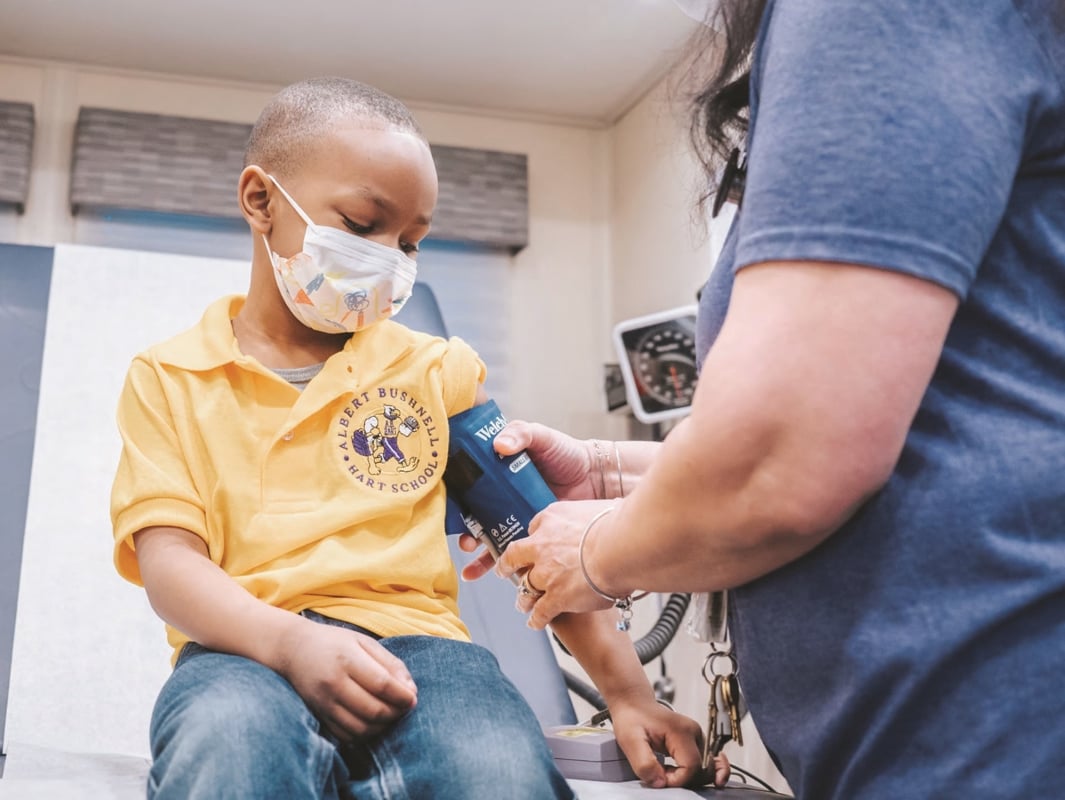 A child getting his blood pressure checked in a school clinic