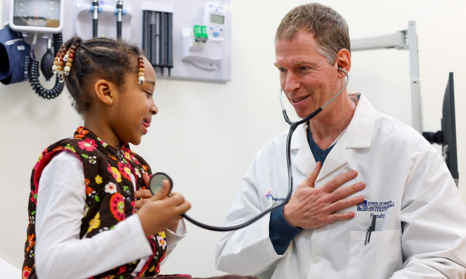 A child holding a MetroHealth doctor's stethoscope