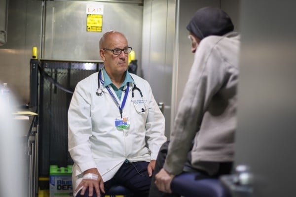 Dr. Siedman talking with a patient inside a mobile clinic