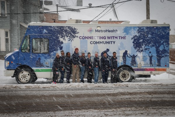 A Mobile Clinic vehicle and its crew on the job in snowy weather