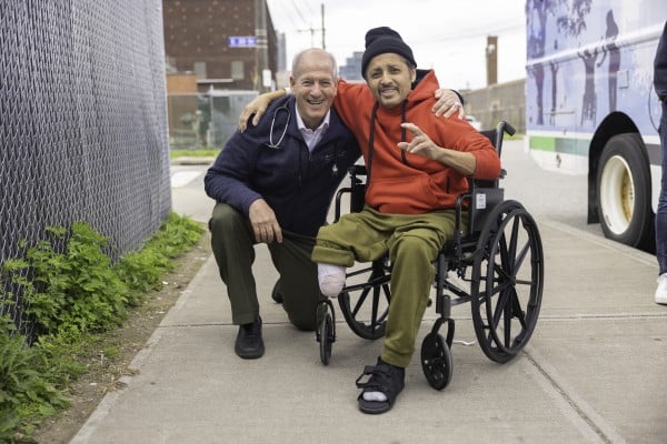 Dr. Seidman and a patient in a wheelchair outside