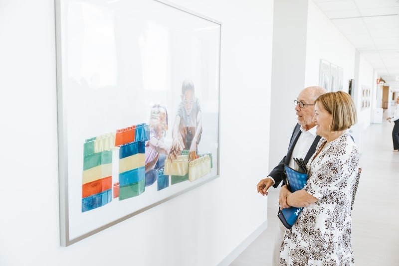 JoAnn and Bob Glick with a painting of children building with blocks