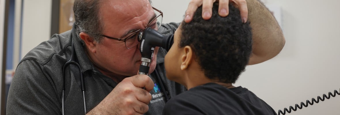 Joh Yousef performing an eye exam