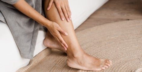 Woman rubbing legs