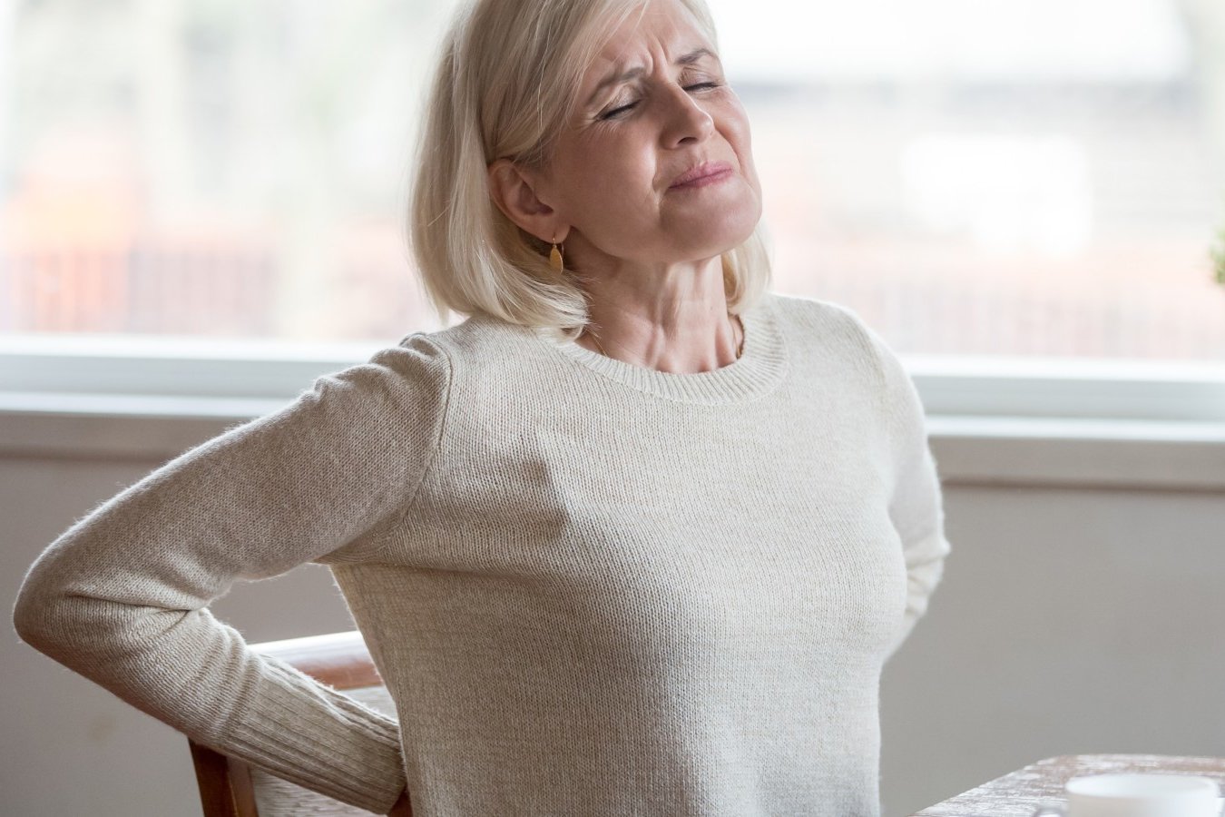 A woman feeling pain in her back