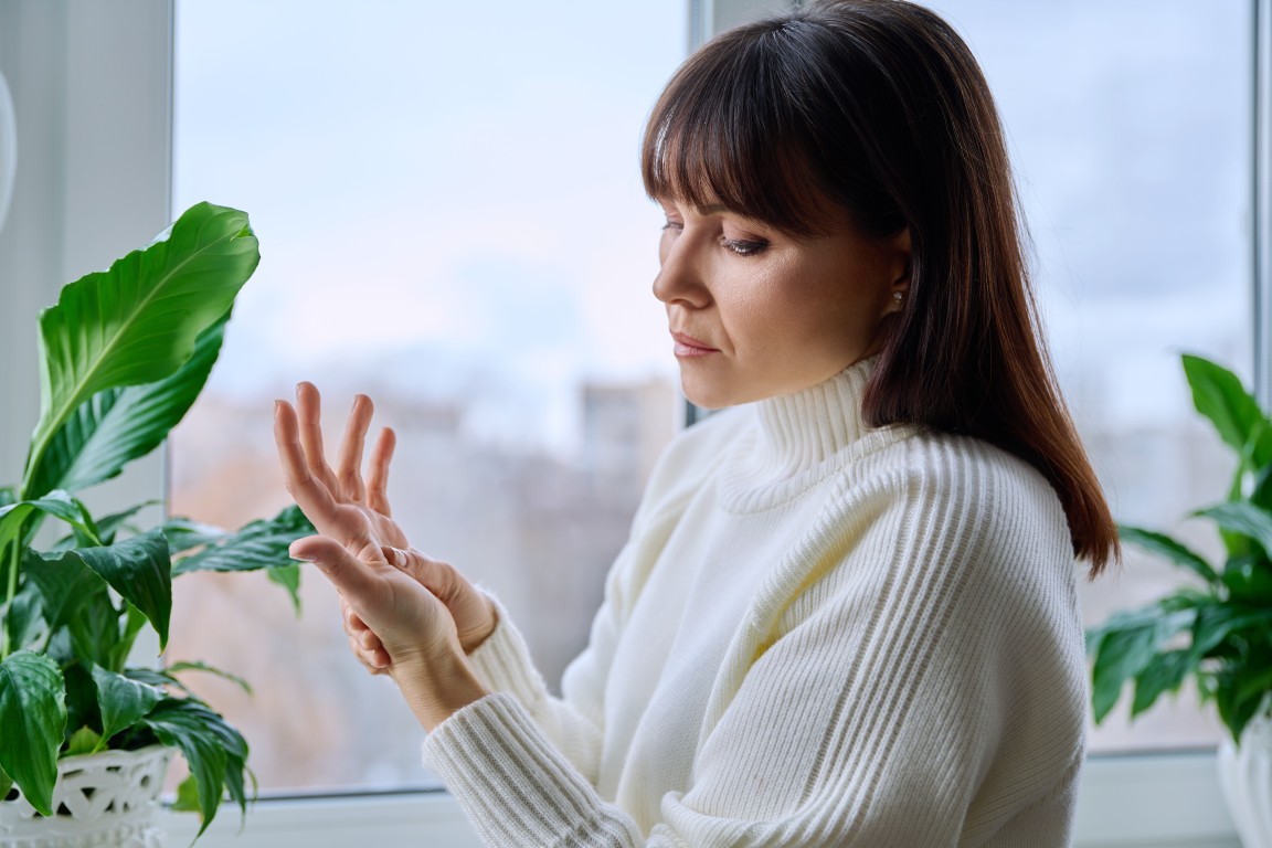 A woman holding her wrist in discomfort