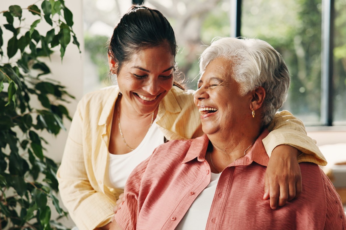 An elderly mother and daughter smiling