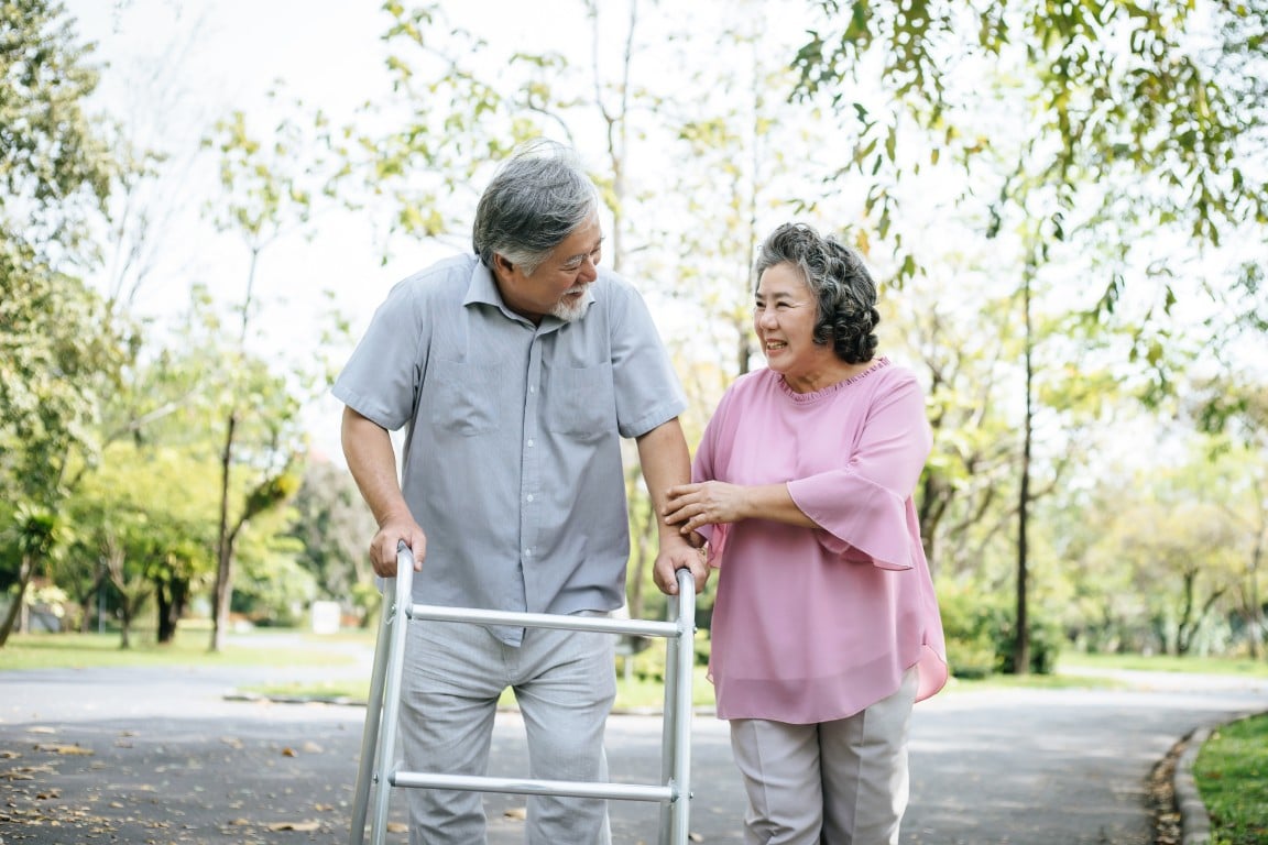 An elderly couple walking in a park