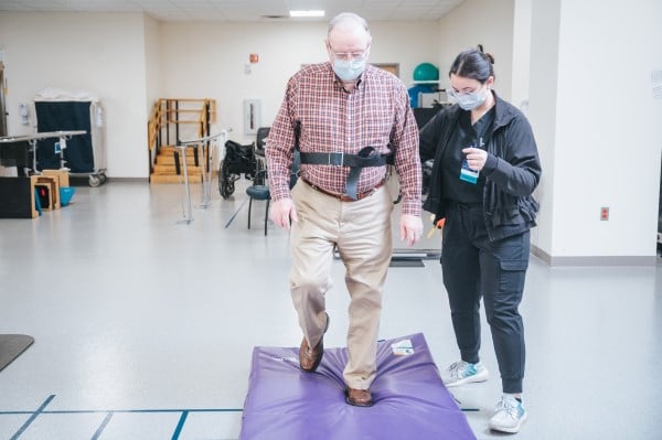 A patient in the MetroHealth Rehabilitation Institute walking again with the help of a therapist