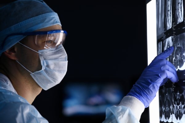 A doctor pointing to a spot on an x-ray image