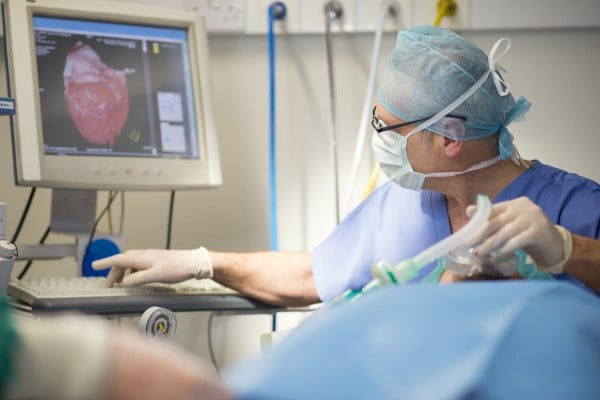 A doctor using an endoscope to perform surgery