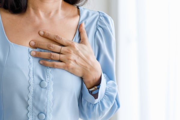 Woman experiencing pain in heart area