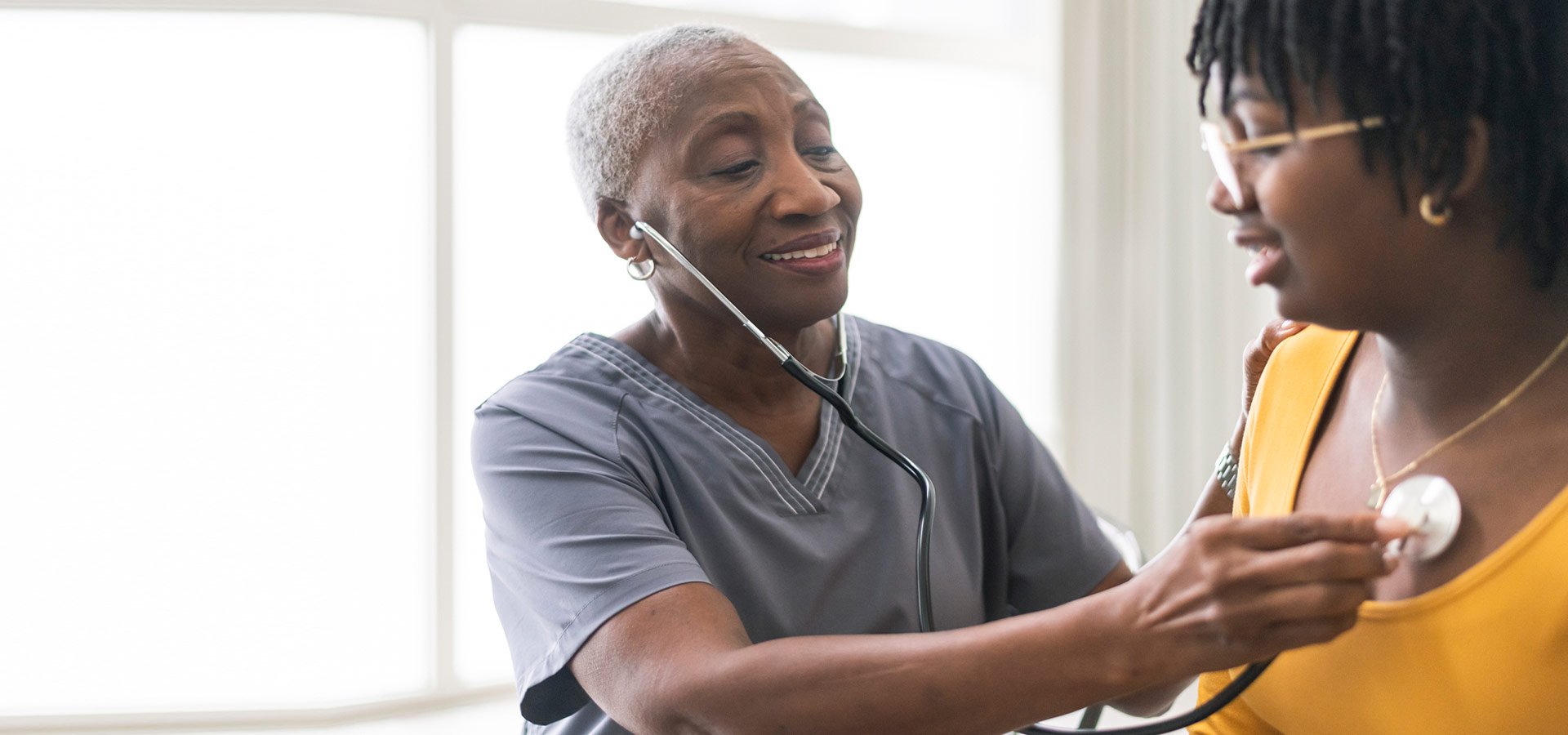 A provider checks a patient's heartbeat