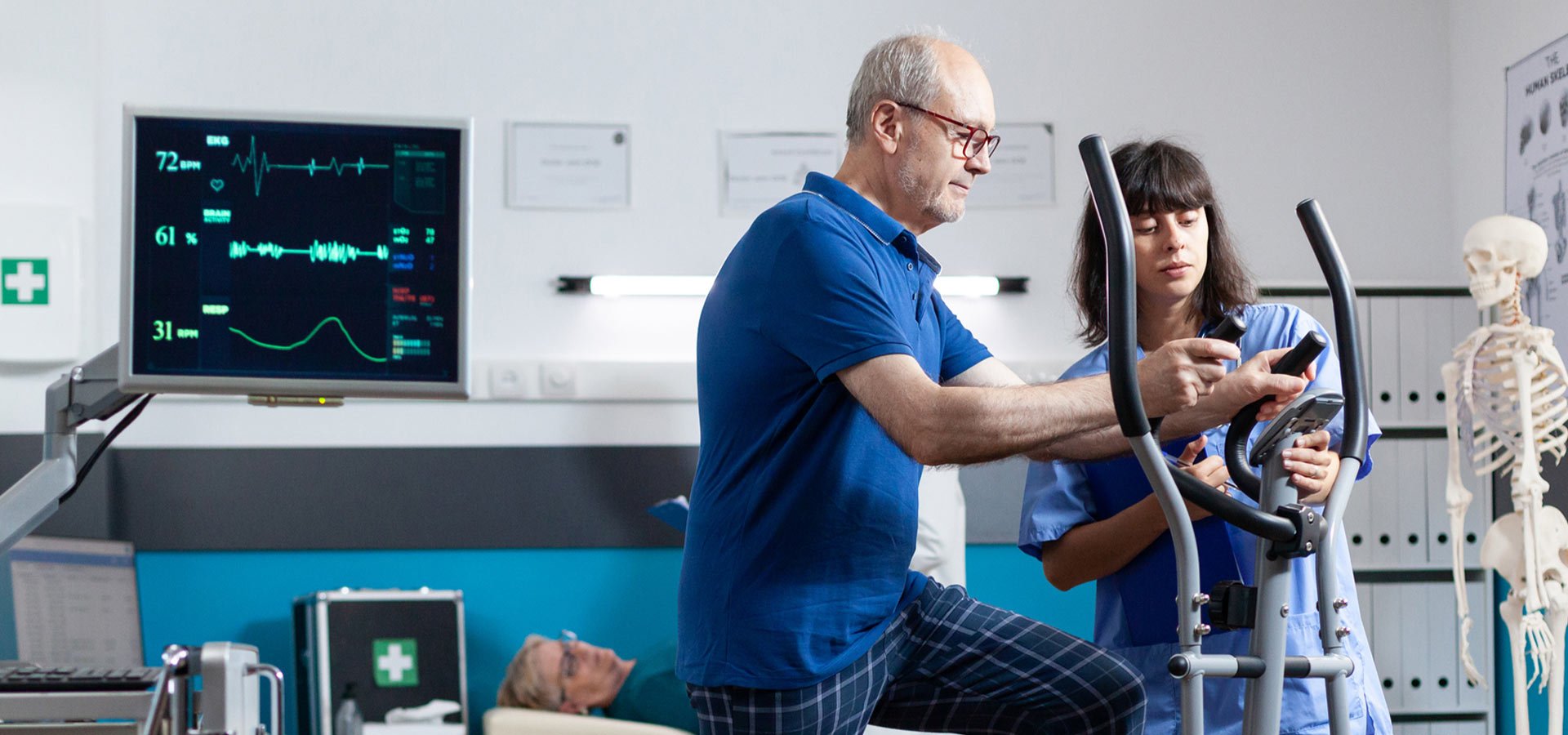 A rehabilitation patient uses an exercise machine while being monitored