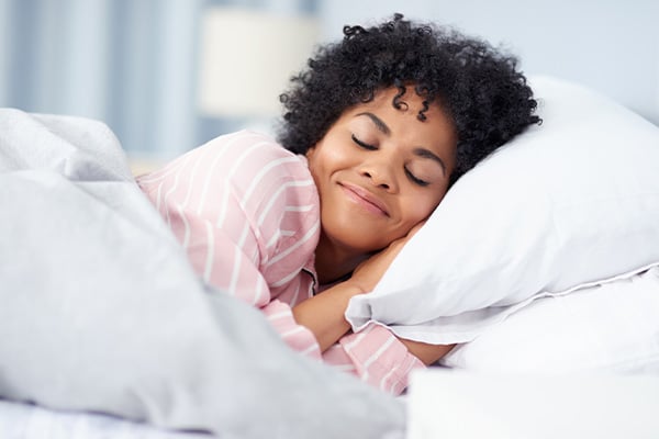 Woman sleeping comfortably in bed