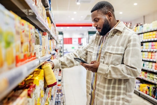 A man considering his choices in a grocery store