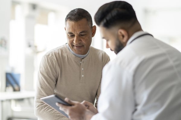 Patient and doctor looking at information together