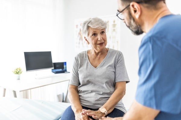 An elderly patient talking to her doctor