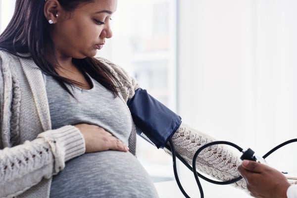 A pregnant woman having her blood pressure checked