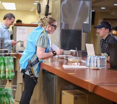 Dee Cottrell working independently at a cafeteria counter