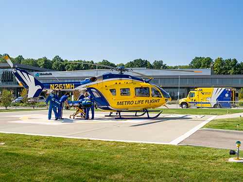 Metro Life Flight helicopter with flight staff nearby