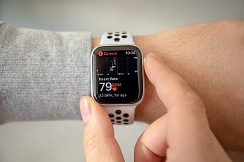 Person checking iPhone watch