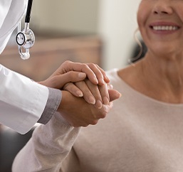 doctor holding patient hand