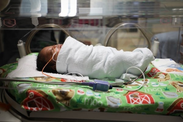Baby in hospital bed