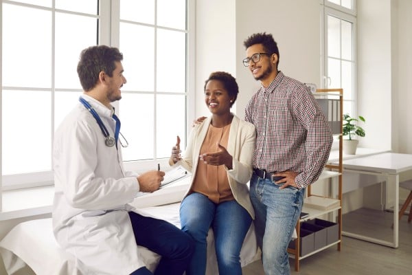 man and woman meeting for consult with doctor