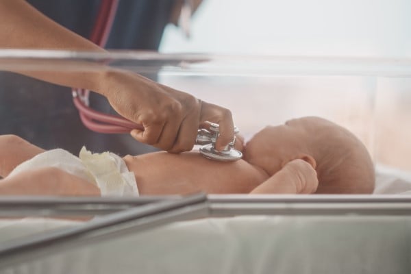 baby being examined with stethoscope